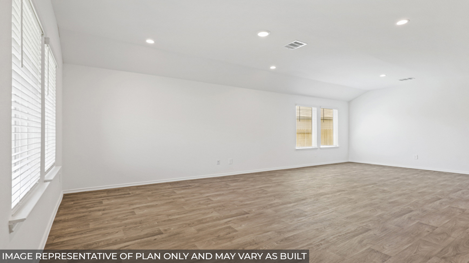 Open concept living and dining space with vinyl flooring and bright windows.