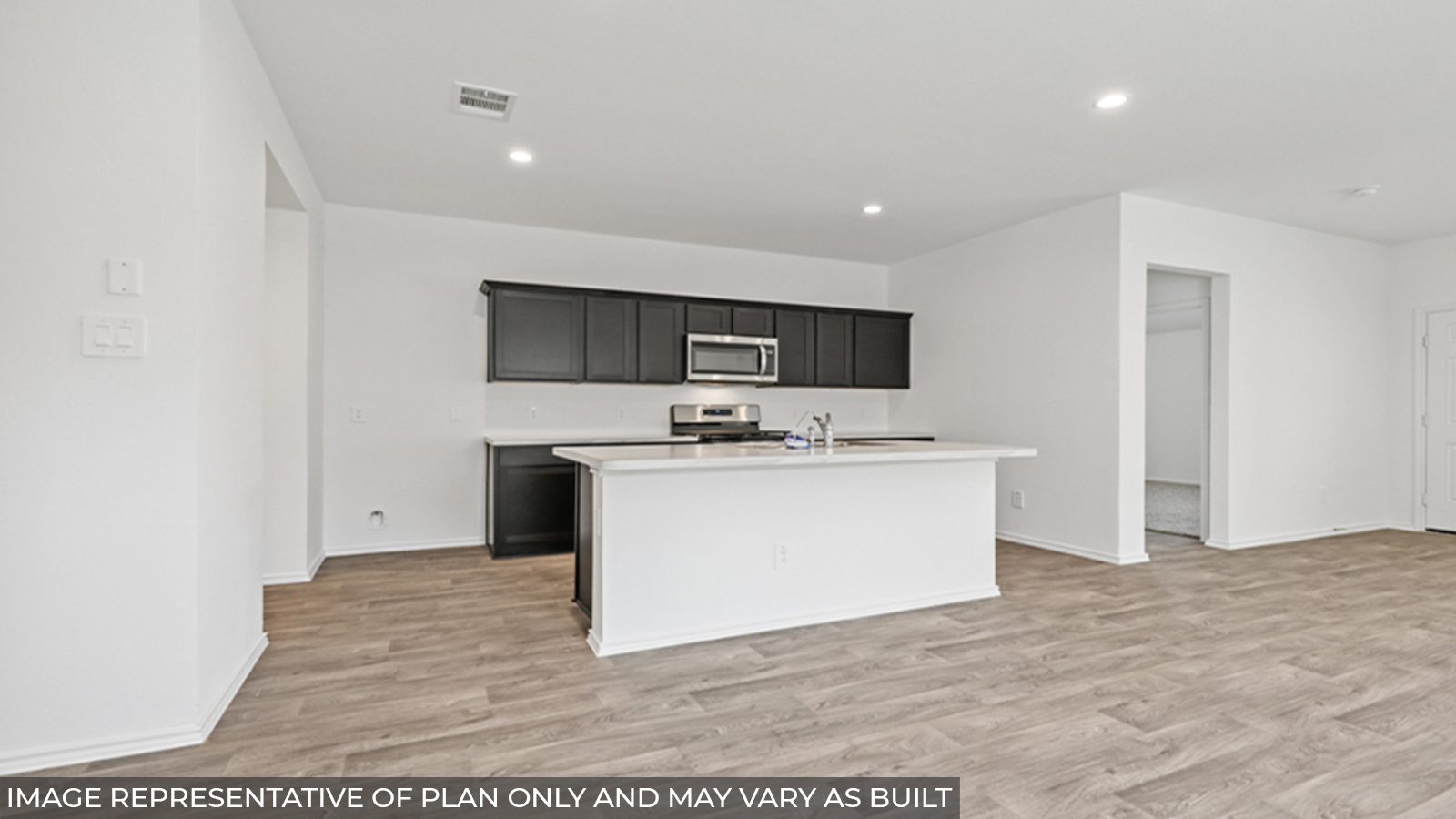 Kitchen with island and stainless-steel appliances.