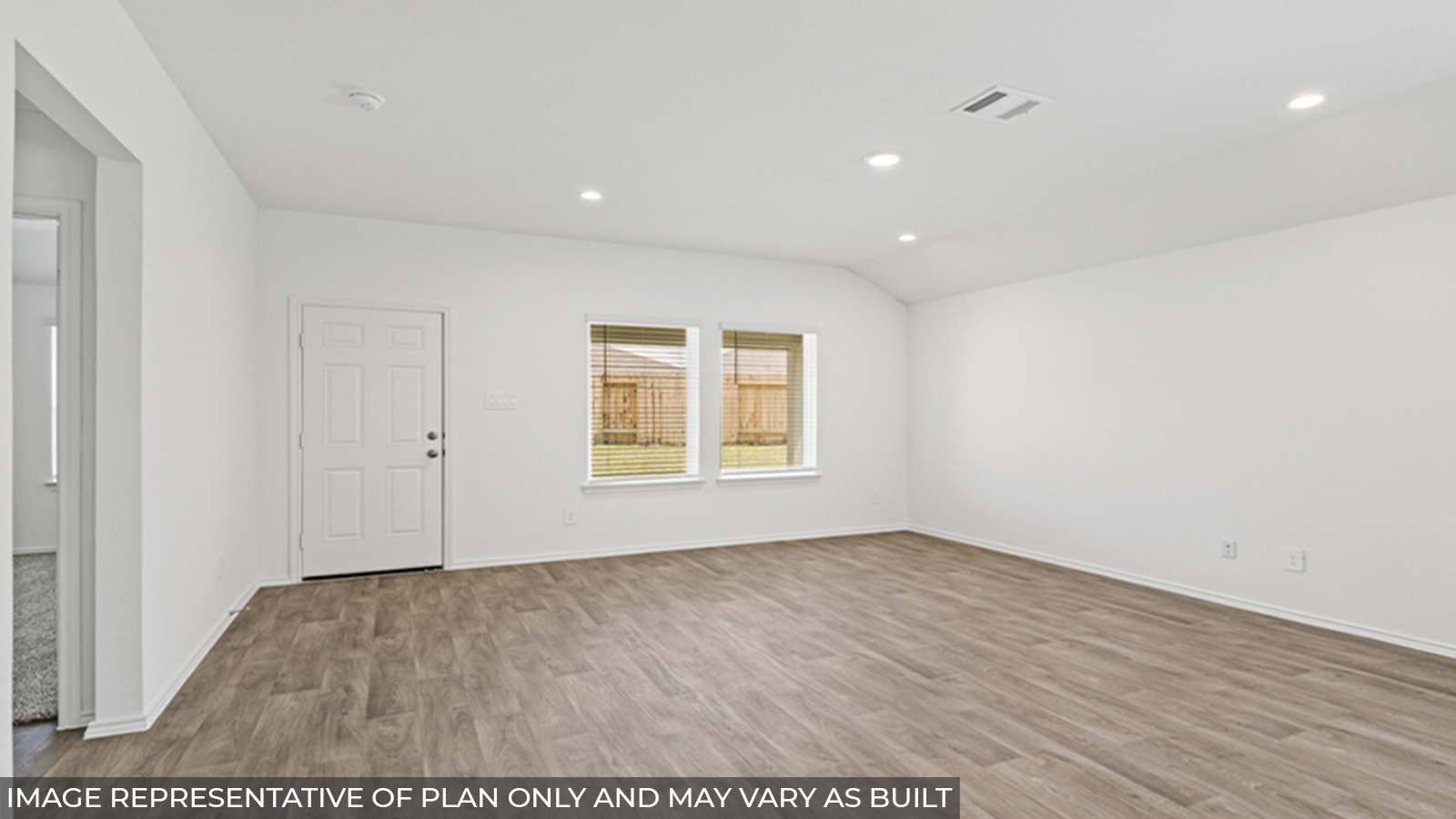 Open concept living and dining space with vinyl flooring and bright windows.