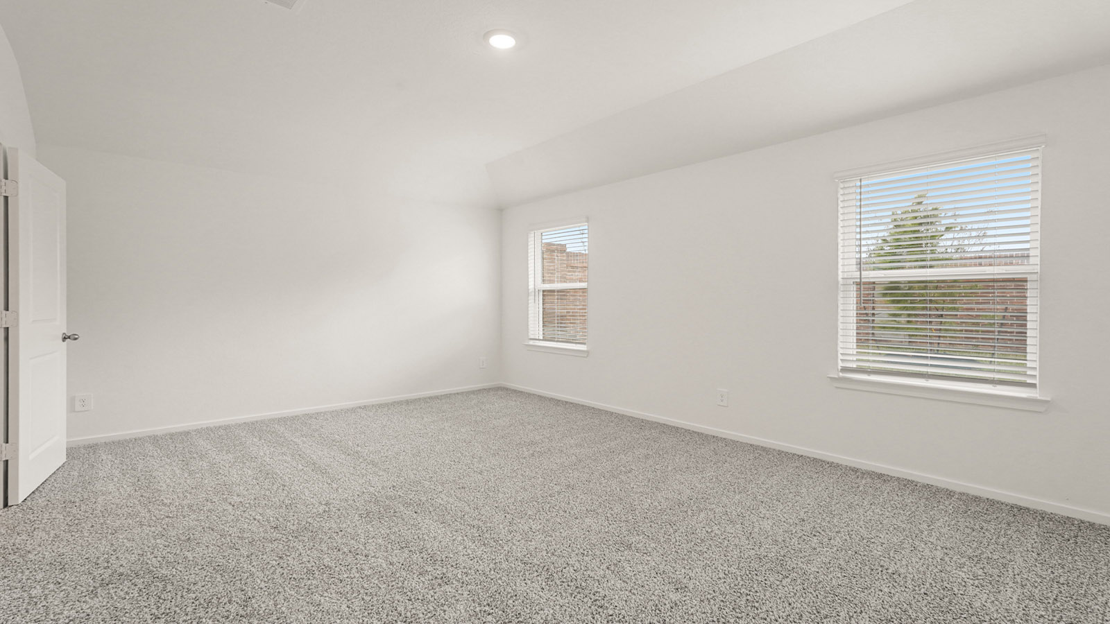Primary bedroom with bright windows