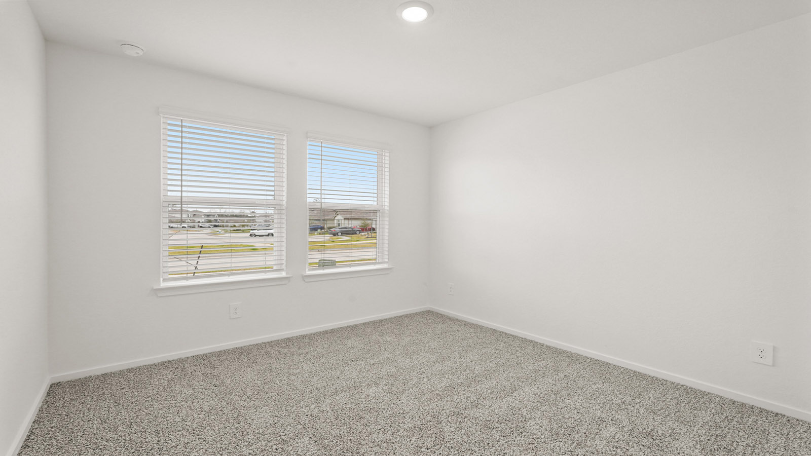 Secondary bedroom with carpet flooring