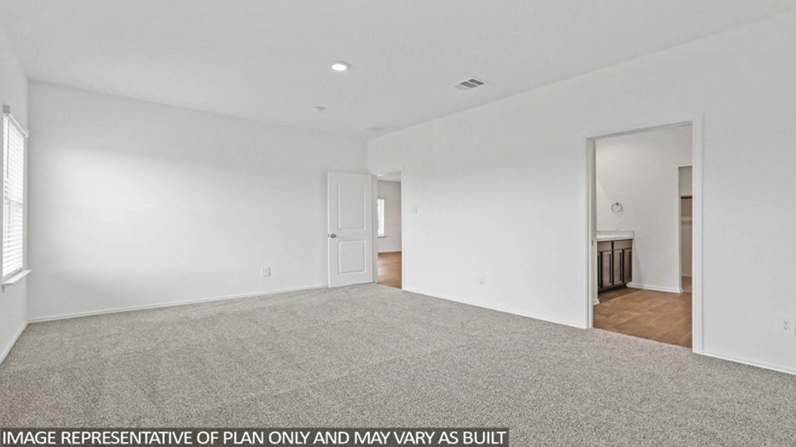 Primary bedroom with carpet flooring