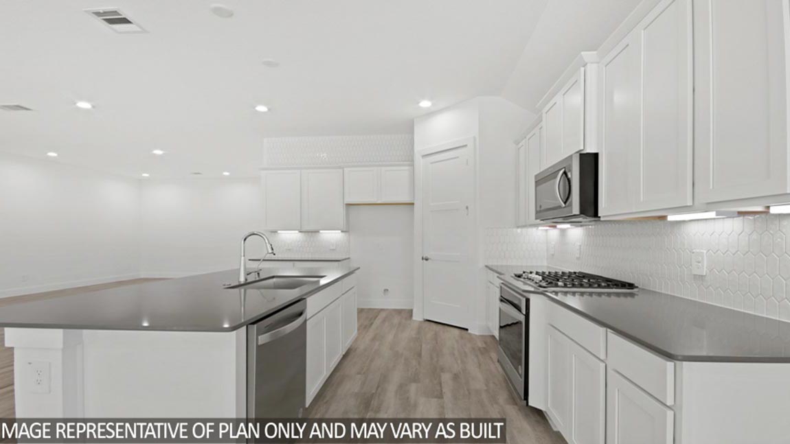Kitchen with an island and stainless-steel appliances.