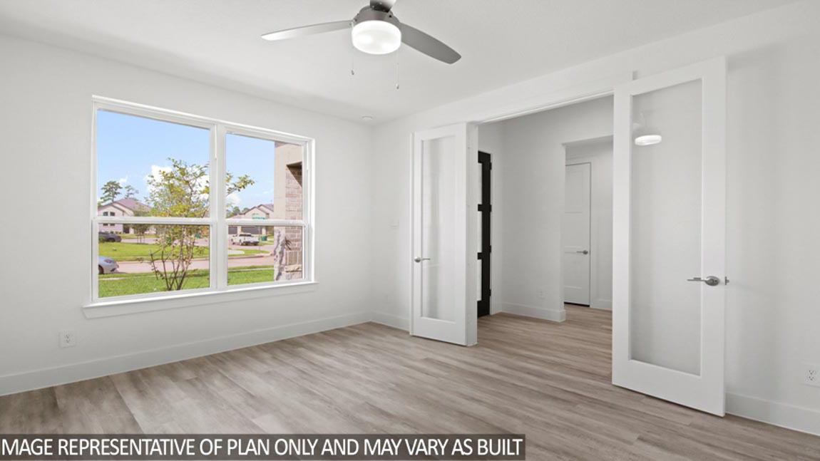 Private study with vinyl flooring, a ceiling fan, and vinyl flooring.