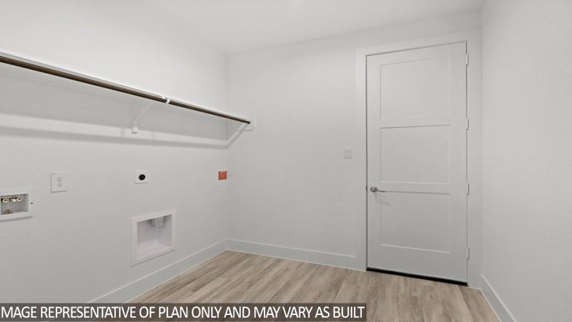 Utility room with vinyl flooring and overhead storage space.