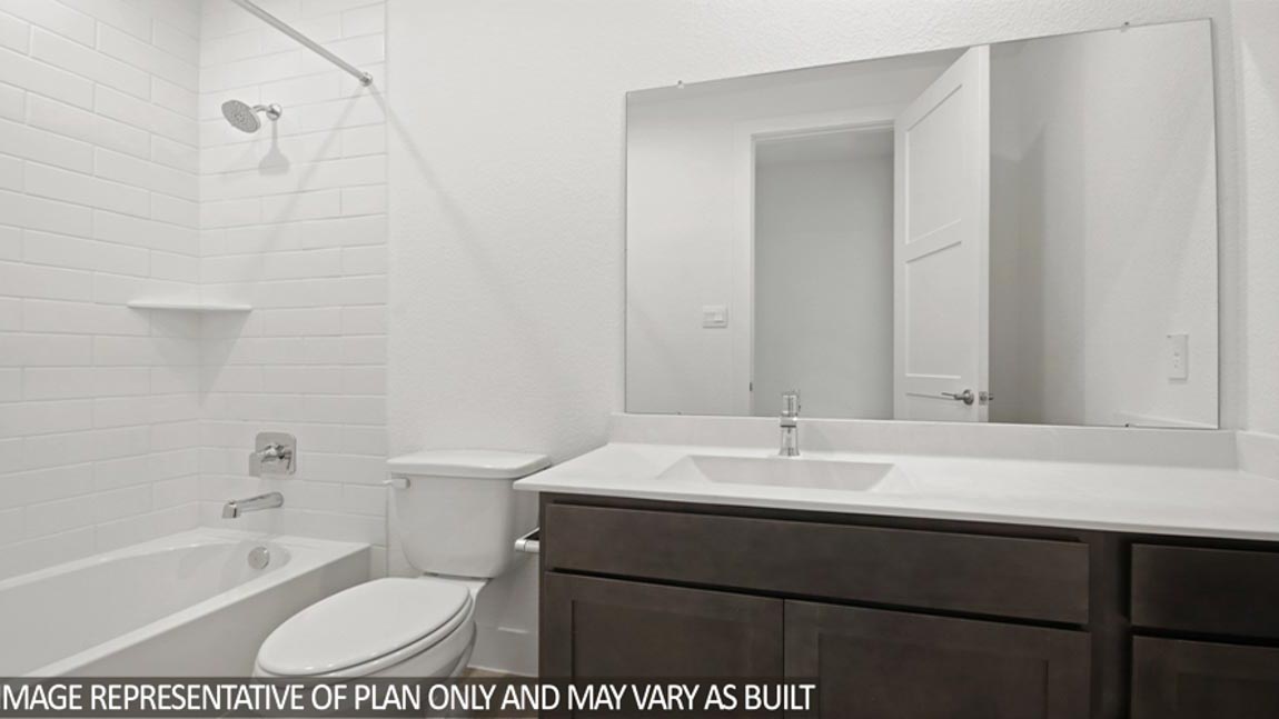 Secondary bathroom with a double sink and a tile tub/shower combo.