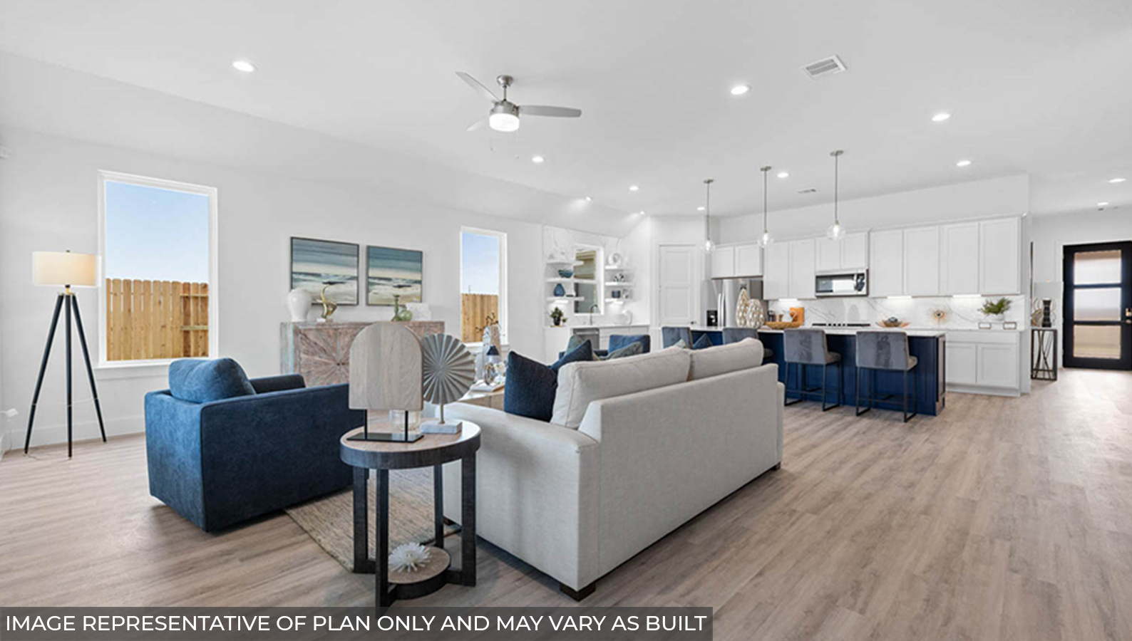 Open concept living and dining area with vinyl flooring and bright windows.