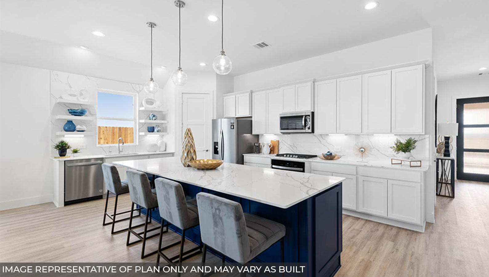 Staged kitchen with an island and stainless-steel appliances.