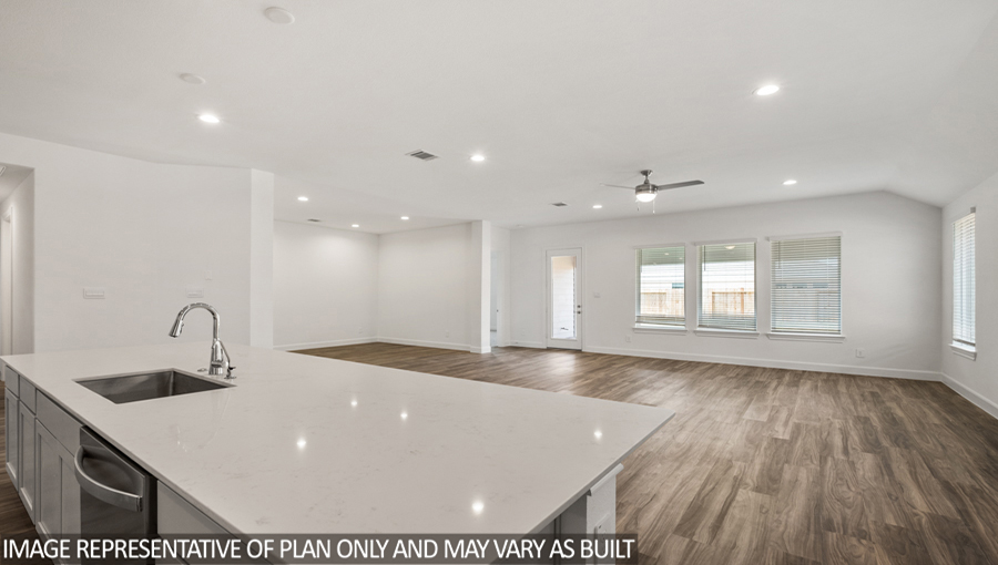 Kitchen with an island, tall pantry, and stainless-steel appliances.