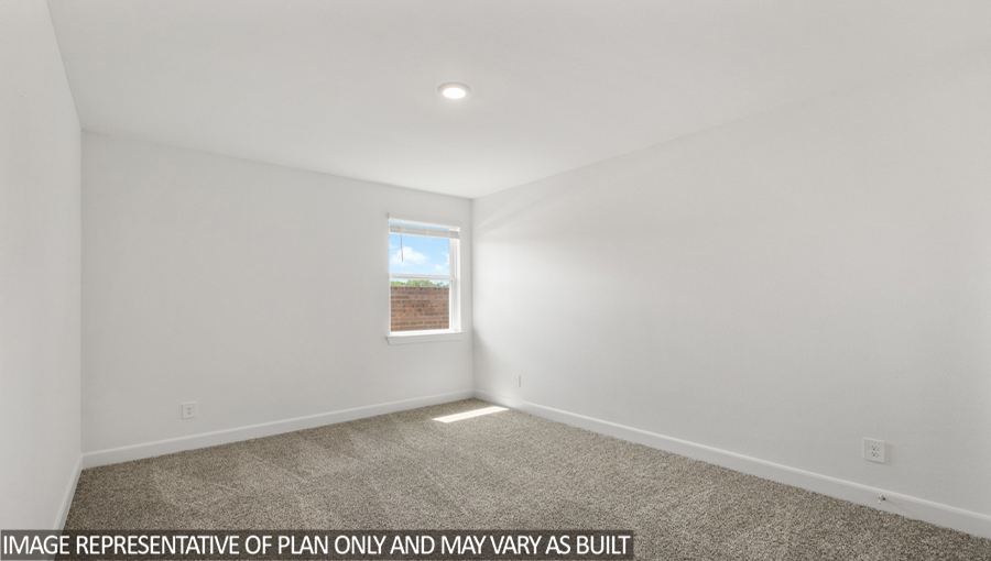 Secondary bedroom with carpet flooring and a bright window.