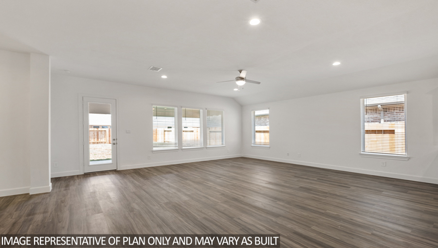 Open concept living and dining space with vinyl flooring and bright windows.