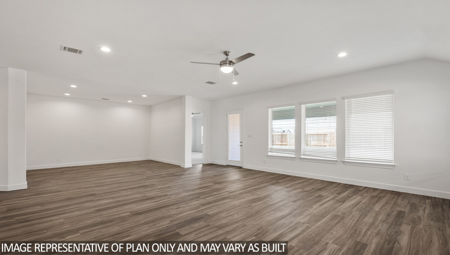 Open concept living and dining space with vinyl flooring and bright windows.