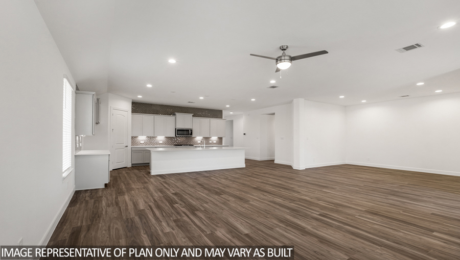 Open concept living and dining space with vinyl flooring and bright windows.