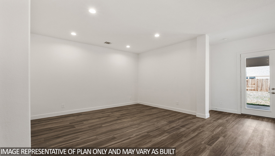 Dining area with vinyl flooring and overhead lights.