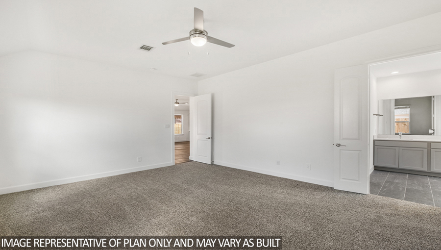 Primary bedroom with a ceiling fan.