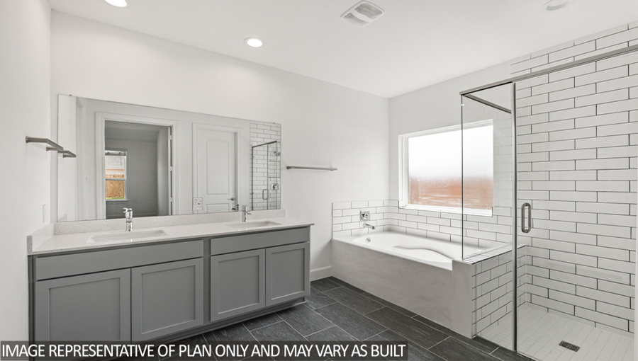 Primary bathroom with a double sink, a separate toilet room, and a walk-in closet.