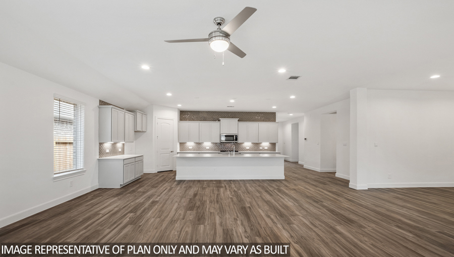 Open concept living and dining space with vinyl flooring and bright windows.