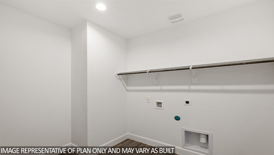 Utility room with vinyl flooring and overhead storage space.