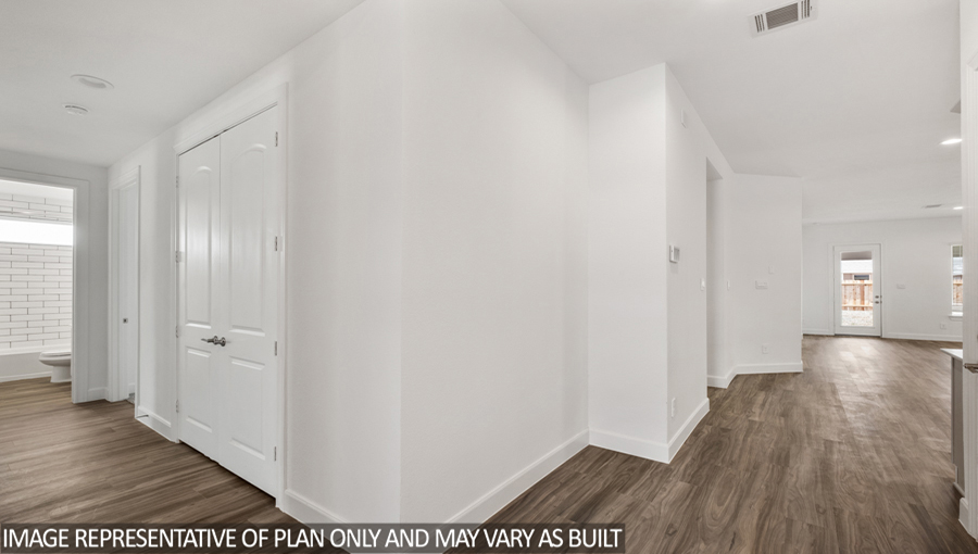Entryway and foyer with vinyl flooring.