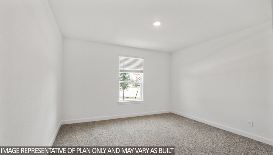 Secondary bedroom with carpet flooring and a bright window.
