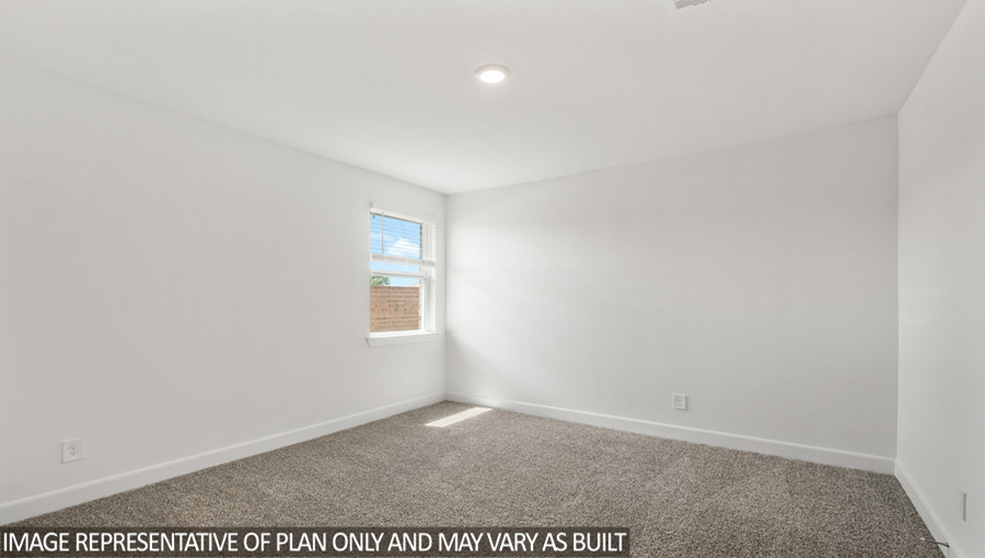 Secondary bedroom with carpet flooring and a bright window.