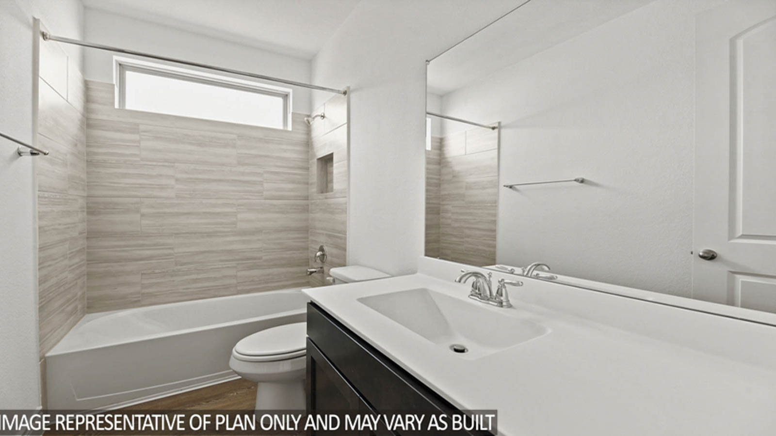 Secondary bathroom with a tile tub/shower combo and a small window.