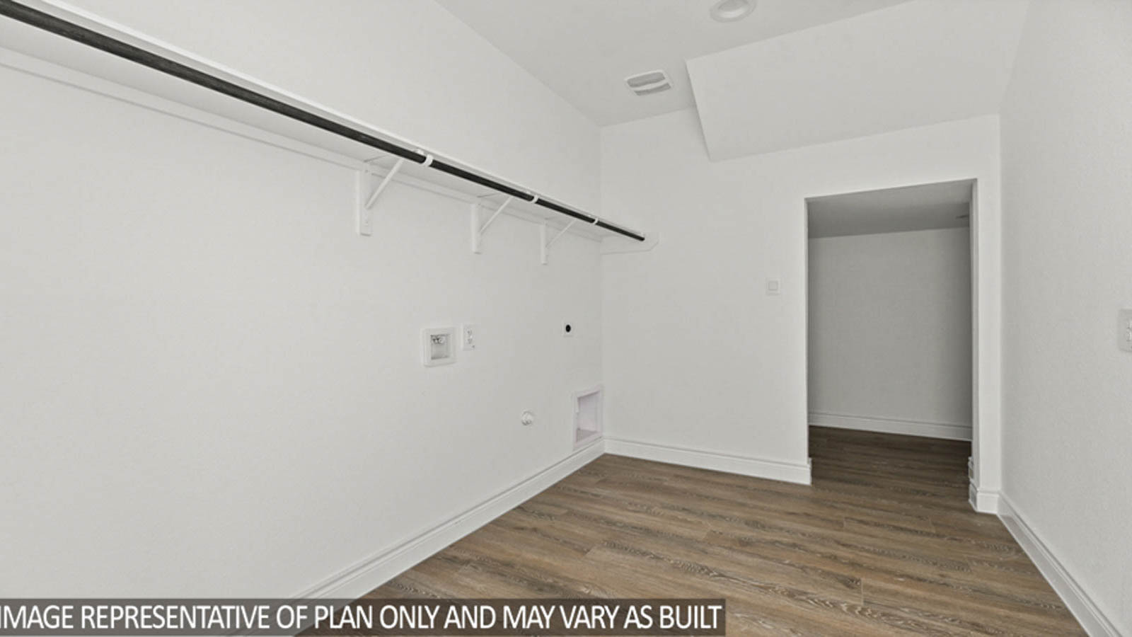 Utility room with vinyl flooring.
