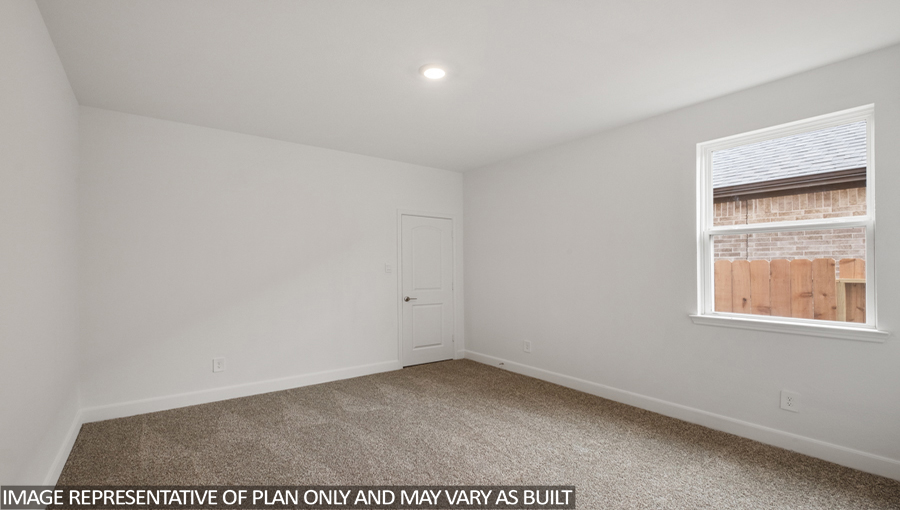 Secondary bedroom with carpet flooring and a bright window.