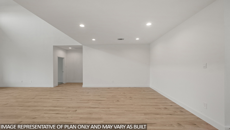 Open concept living and dining area with vinyl flooring and bright windows.