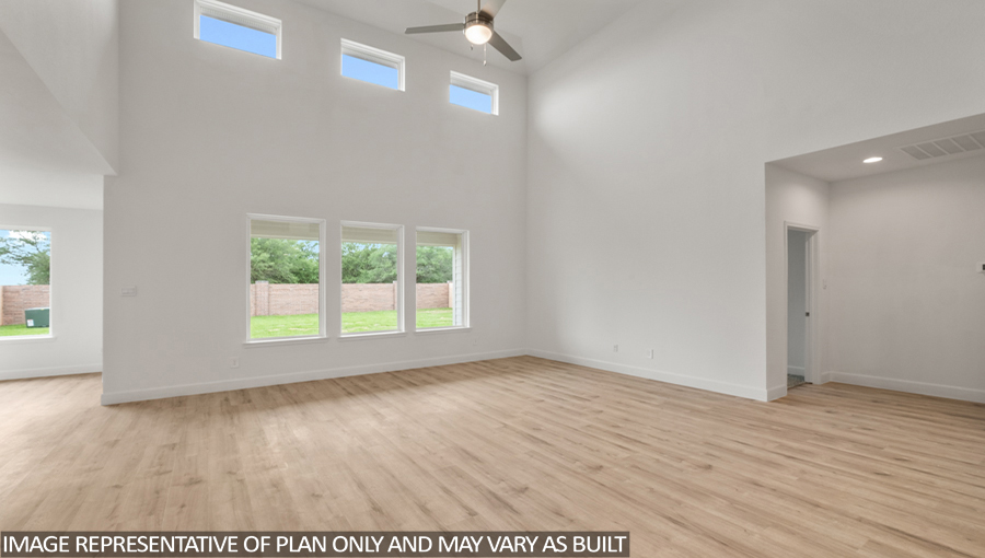 Open concept living and dining area with vinyl flooring and bright windows.
