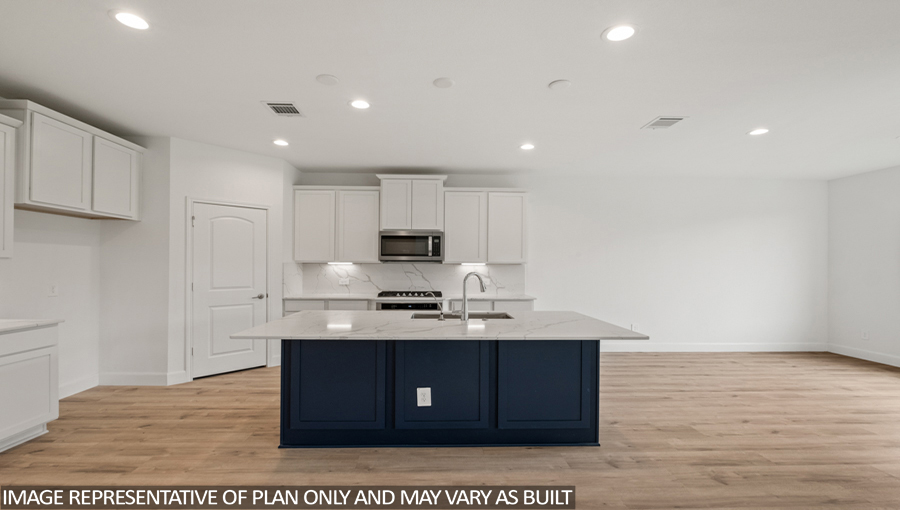 Kitchen with an island and stainless-steel appliances.