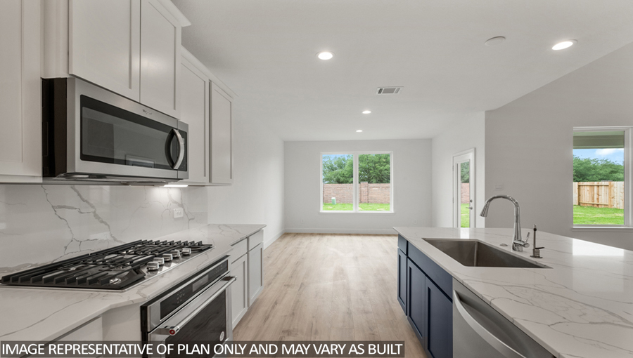 Kitchen with an island and stainless-steel appliances.