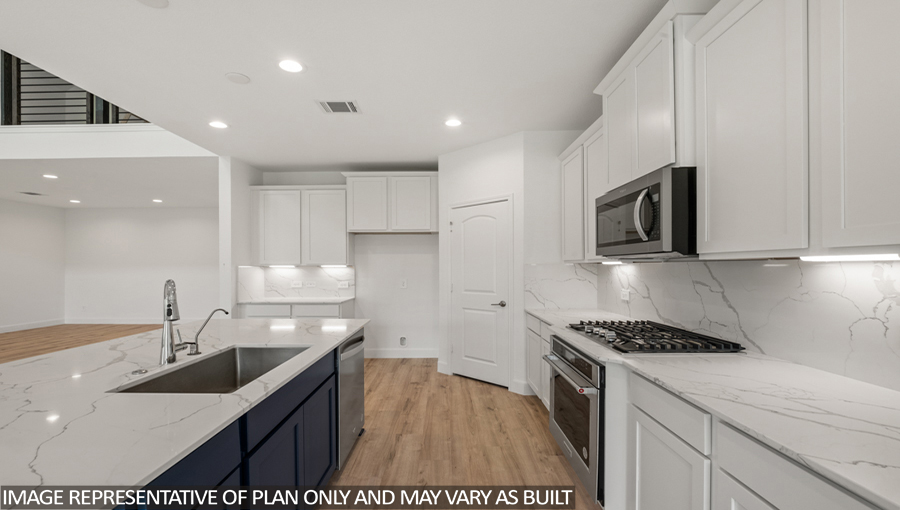 Kitchen with an island and stainless-steel appliances.