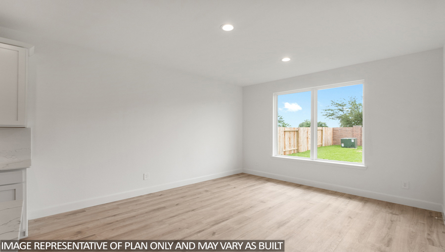 Breakfast area with vinyl flooring and bright windows.