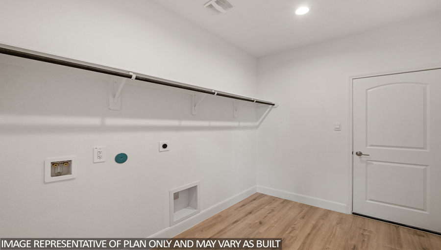 Utility room with vinyl flooring and overhead storage space.