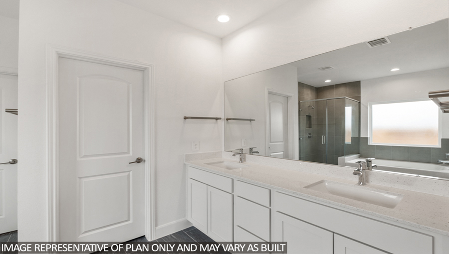 Primary bathroom with a double sink and vinyl flooring.
