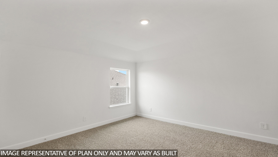 Secondary bedroom with carpet flooring and a bright window.