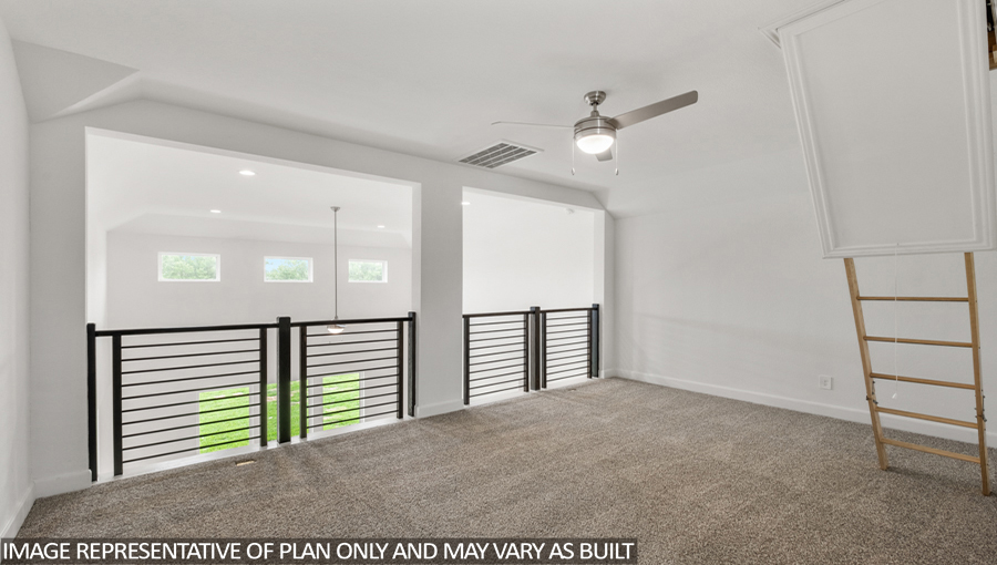 Upstairs loft with carpet flooring, a balcony overlooking the family room downstairs, and an entrance to the attic.