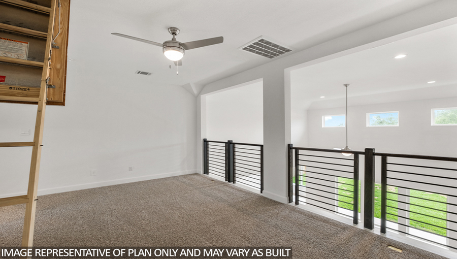 Upstairs loft with carpet flooring, a balcony overlooking the family room downstairs, and an entrance to the attic.