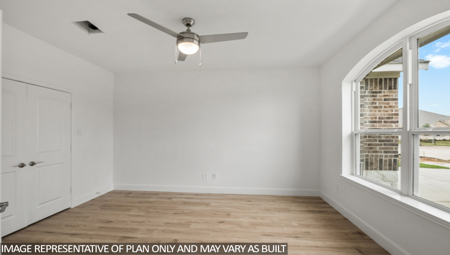 Private study with vinyl flooring, a bright window, and a ceiling fan.