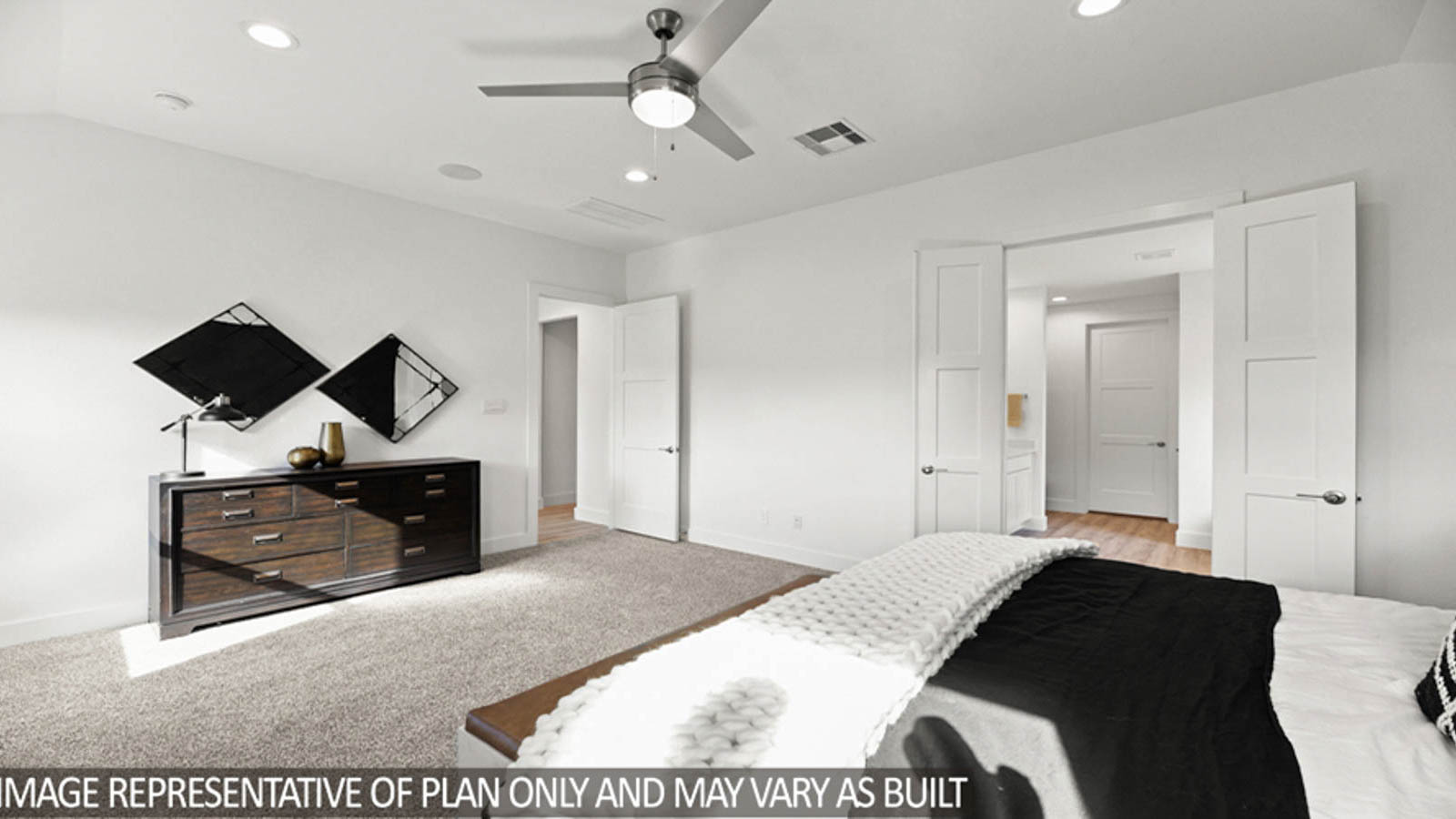 Primary bedroom with carpet flooring, a bright window, and a ceiling fan.