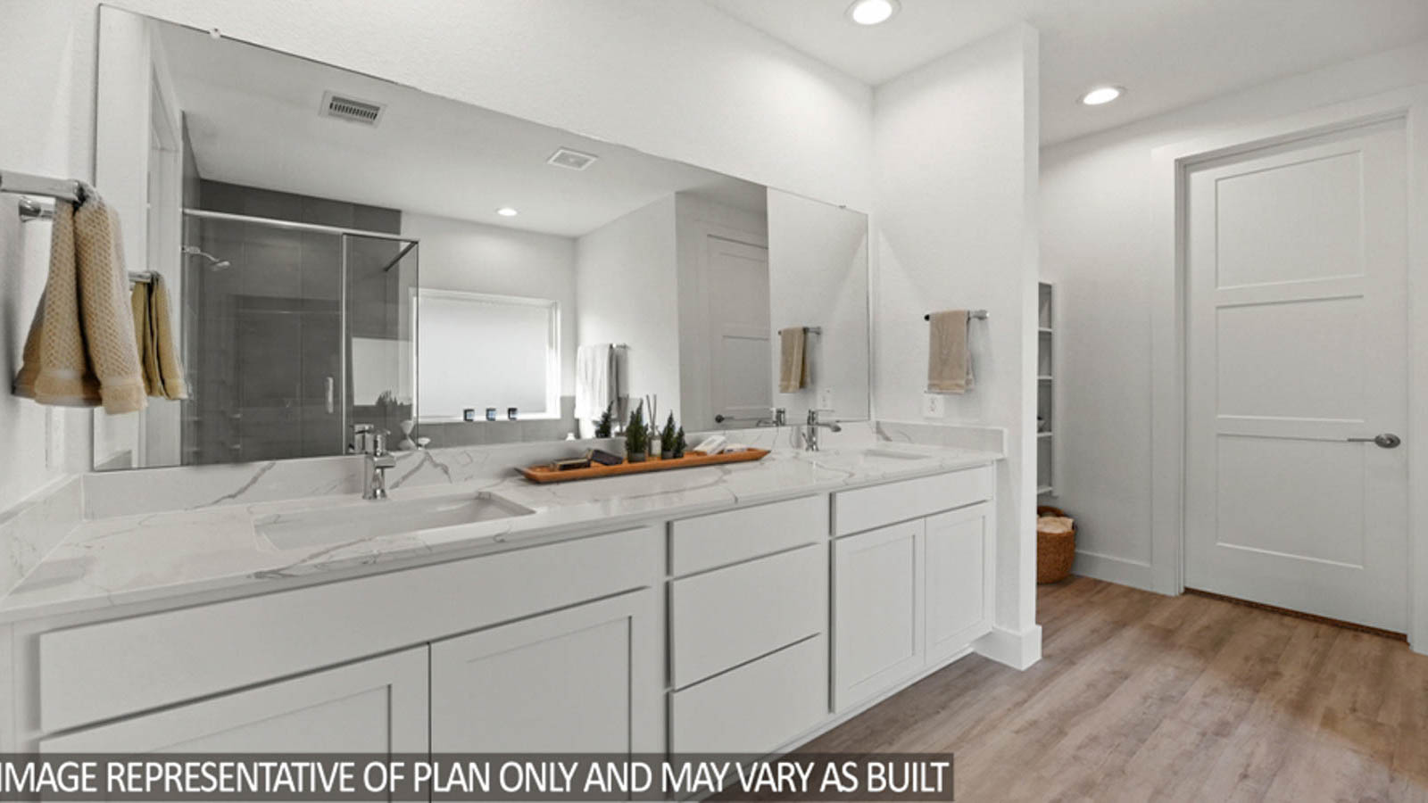 Primary bathroom with a double sink and vinyl flooring.