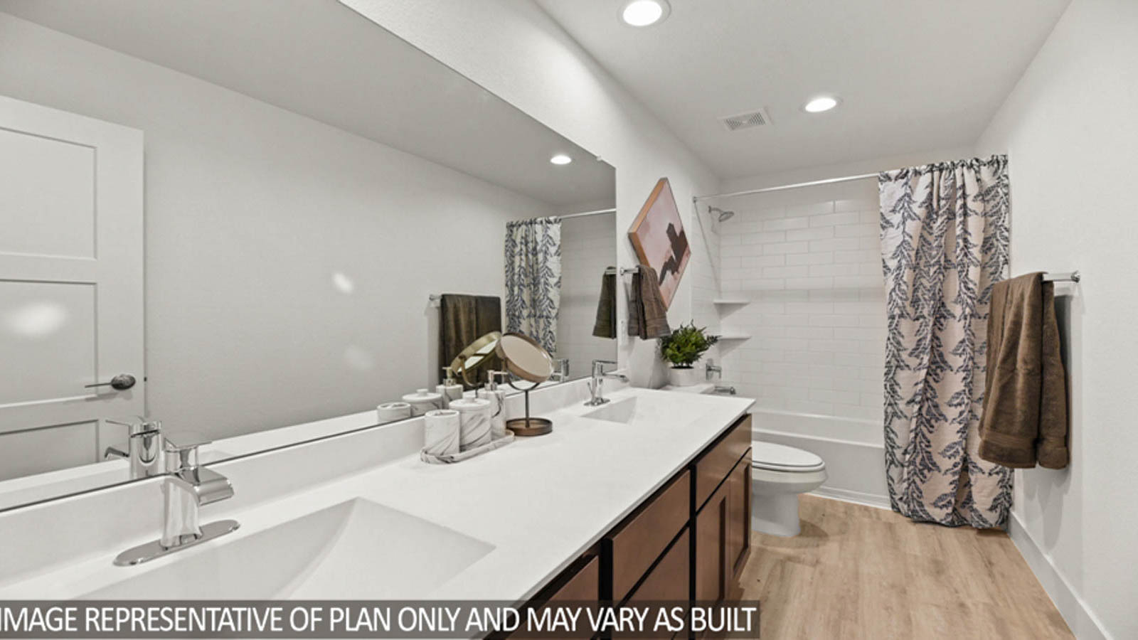 Secondary bathroom with a double sink and a tile tub/shower combo.