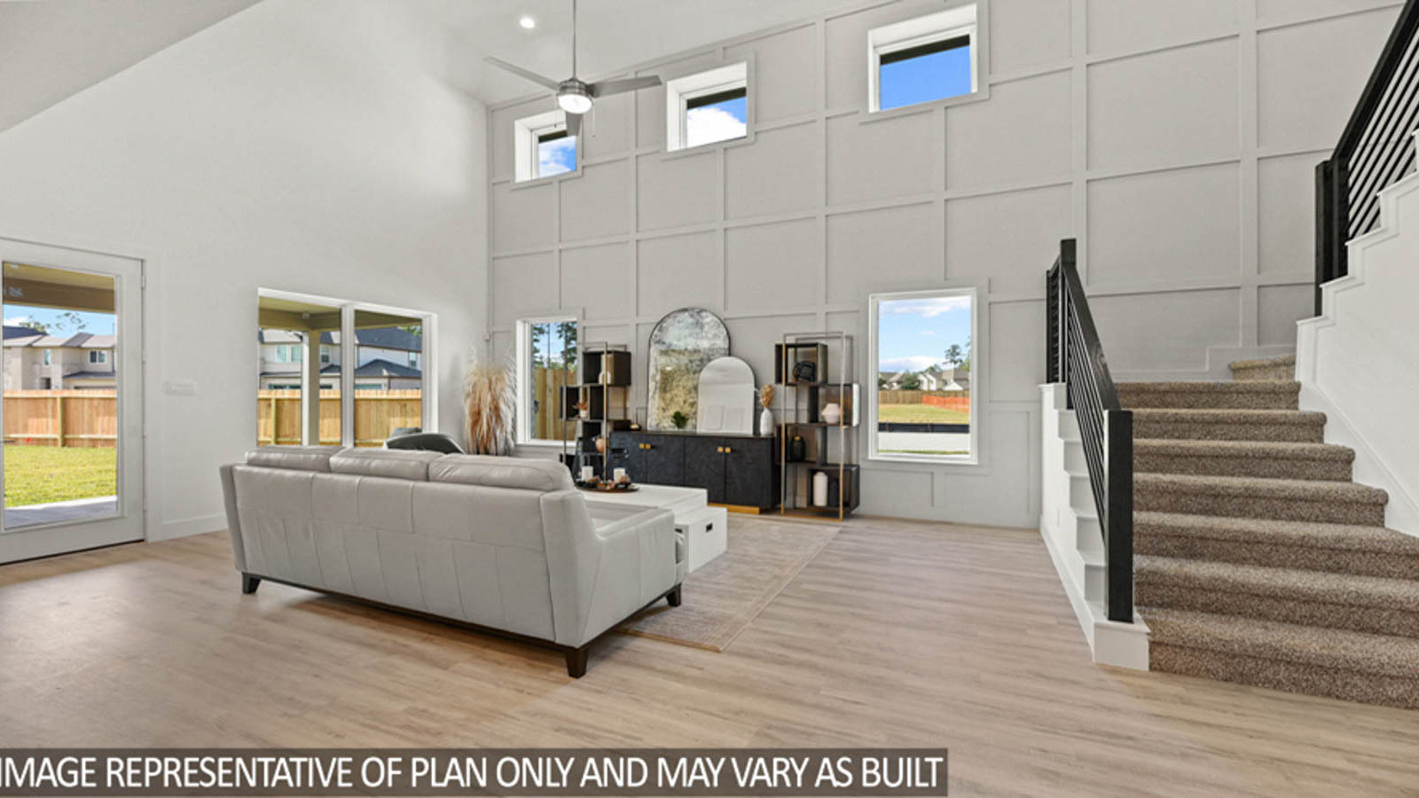 Open concept living and dining area with vinyl flooring and bright windows.