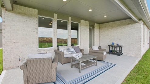 Large back patio with overhead lighting