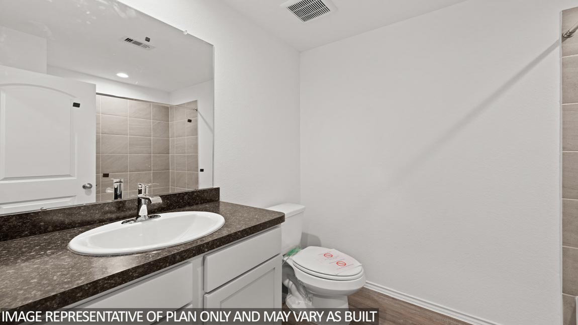 Secondary bathroom with vinyl flooring.