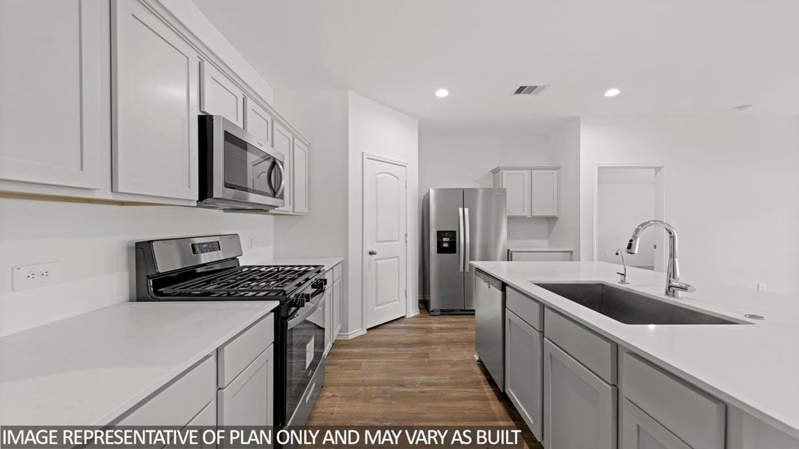 Kitchen with an island and stainless-steel appliances.