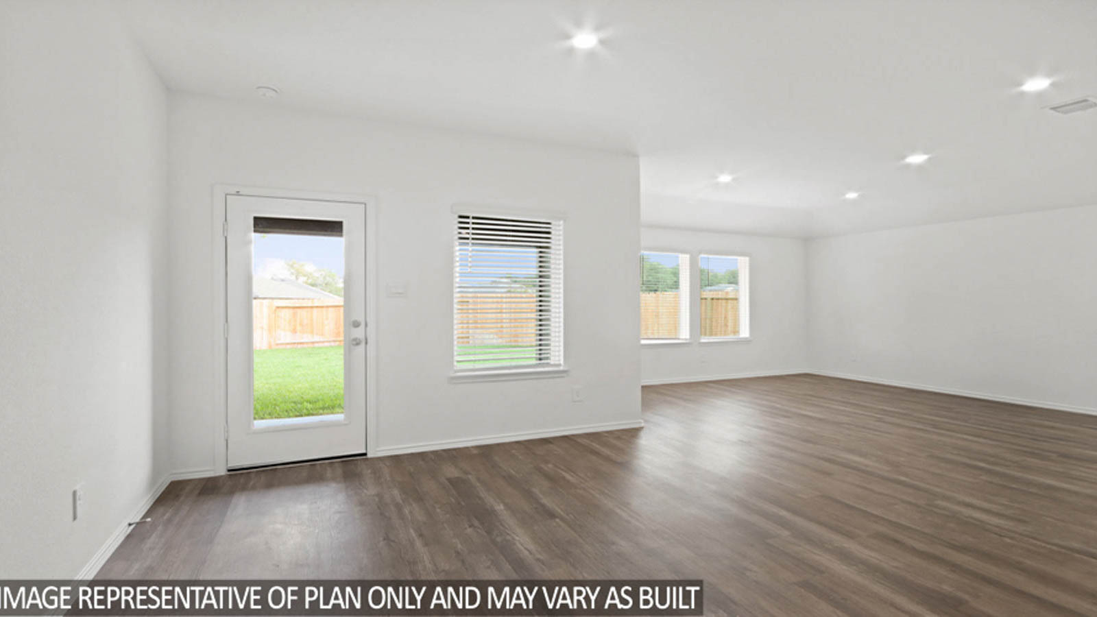 Open concept living and dining space with vinyl flooring.