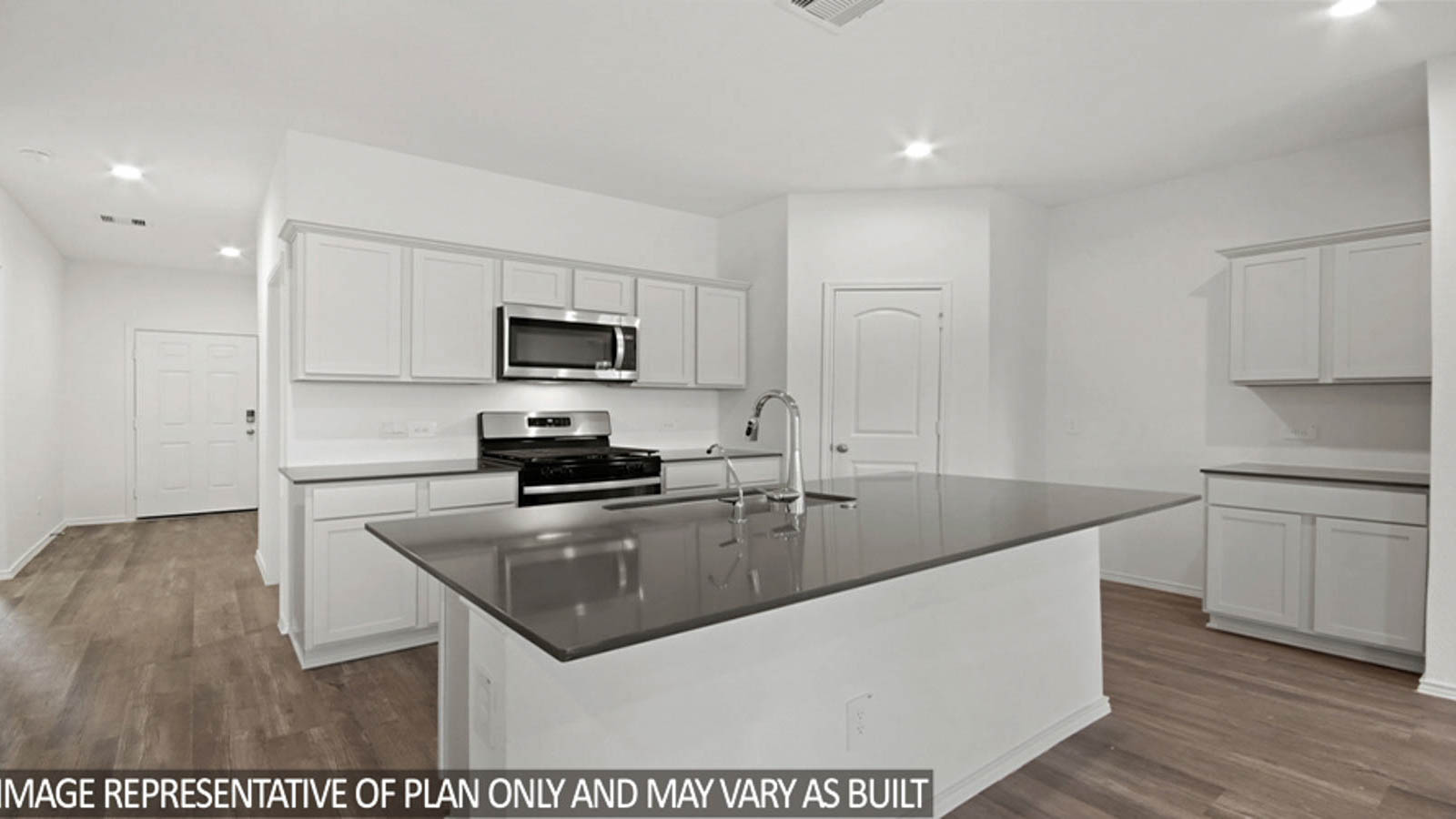 Kitchen with an island and stainless-steel appliances.