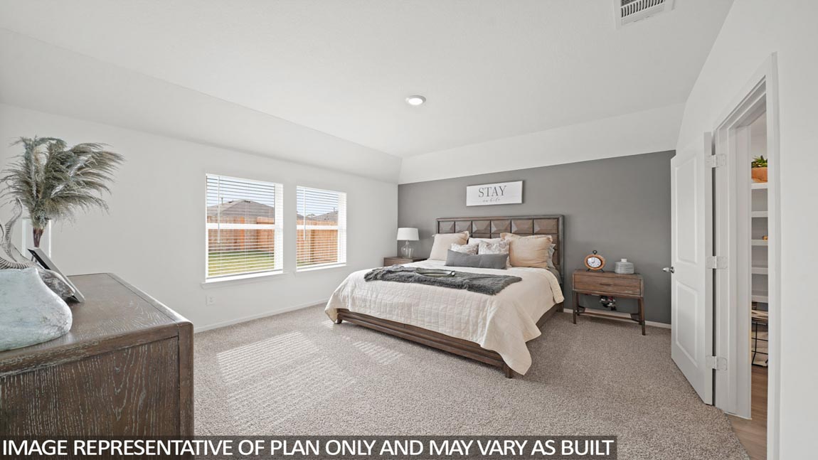 Primary bedroom with bright windows
